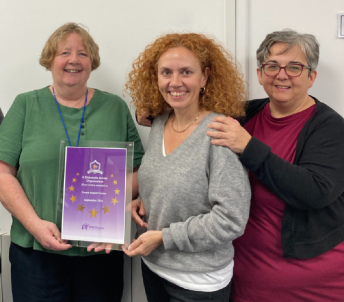 Carers Support staff members proudly hold an award